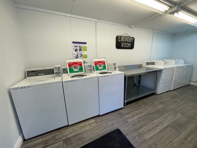 On-site coin-operated laundry room with washers and dryers at Angleton RV Park & Resort